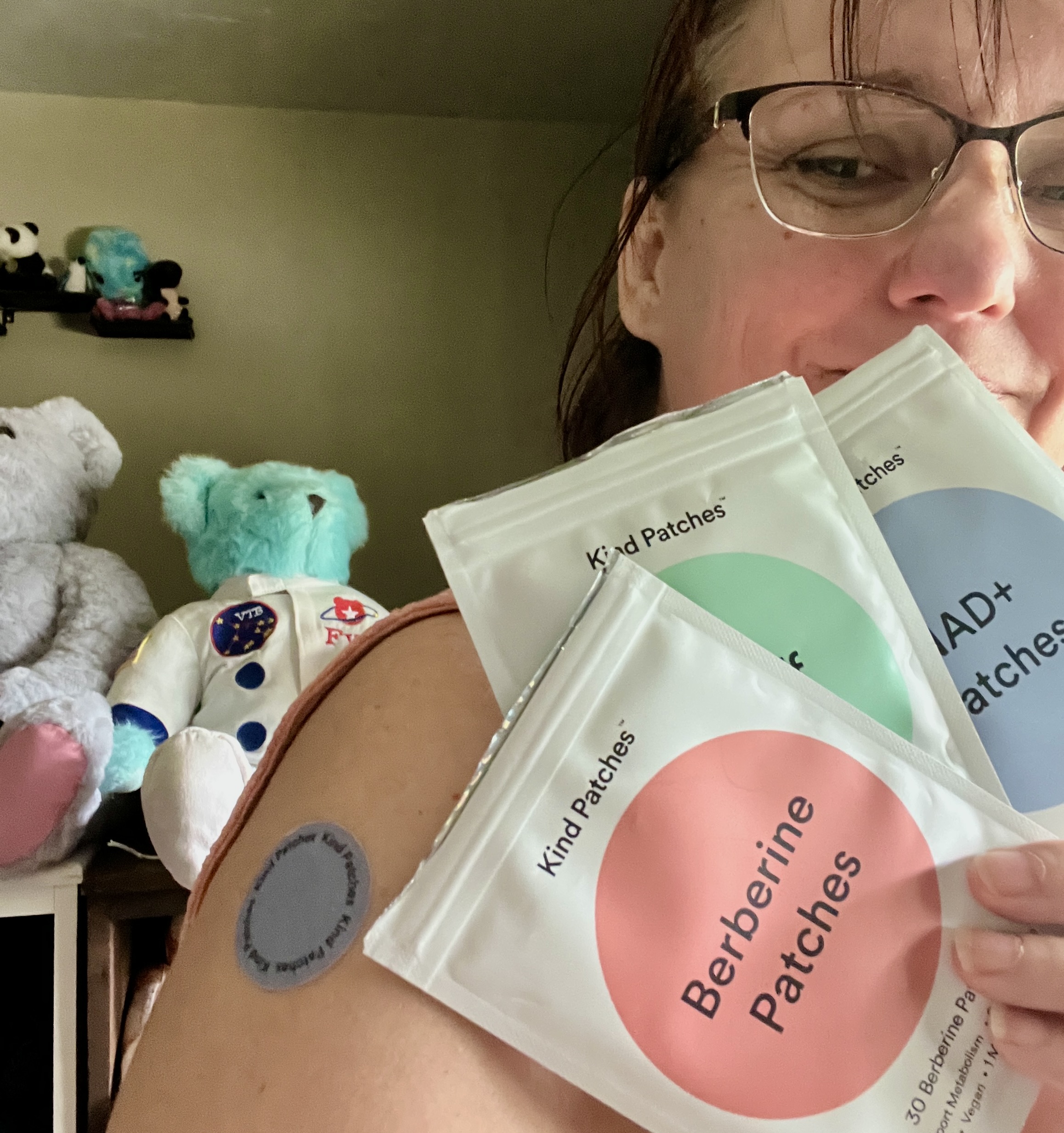 Holding several Kind Patches products from the Metabolic Wellness Protocol