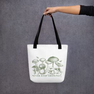Never Stop Growing tote bag, white canvas print, black handles, lifestyle mockup